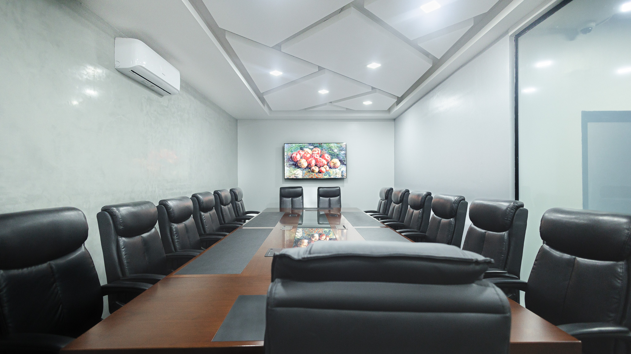 Spacious modern office with large windows and greenery