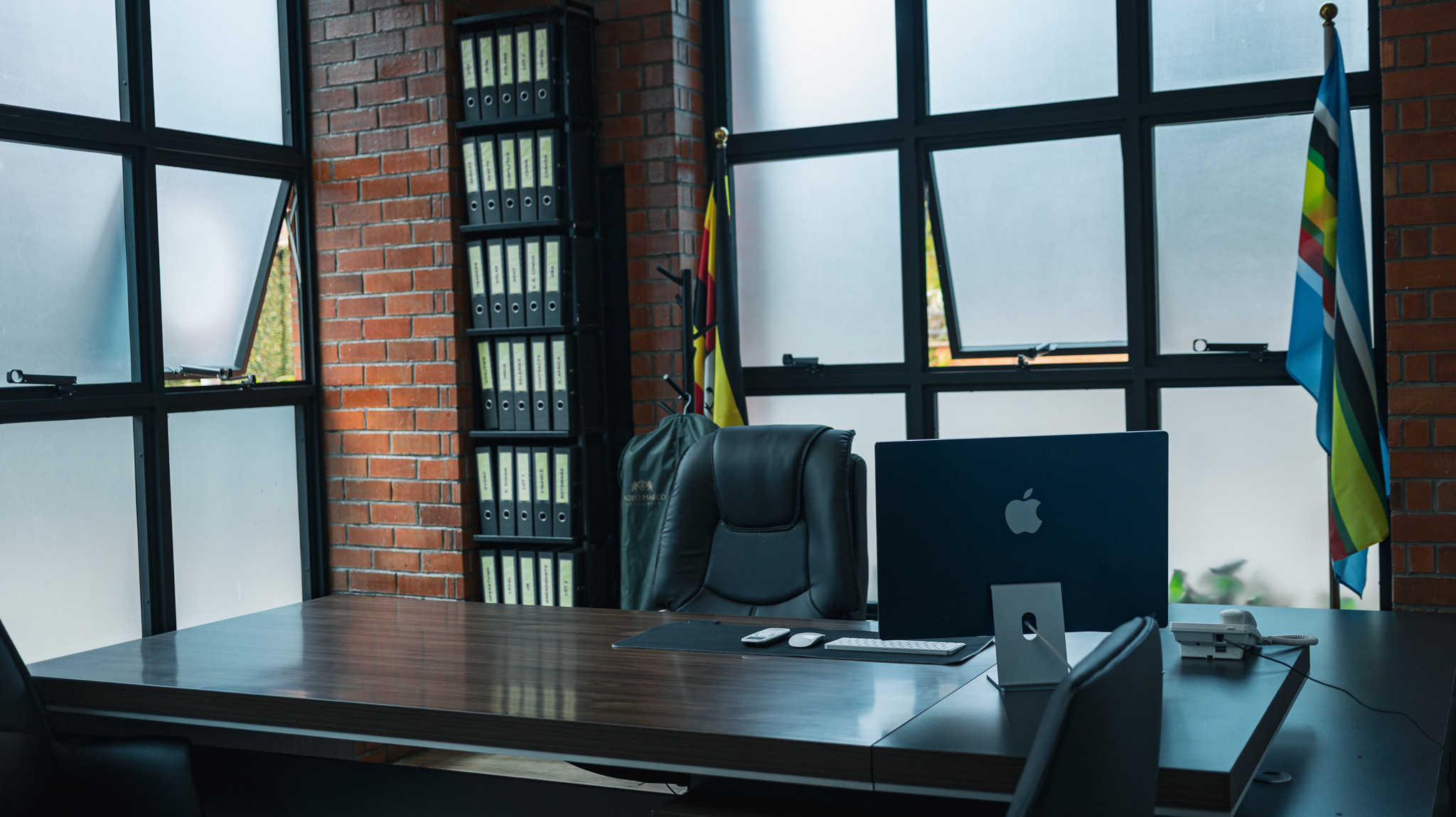 Open office workspace with long desks and modern lighting