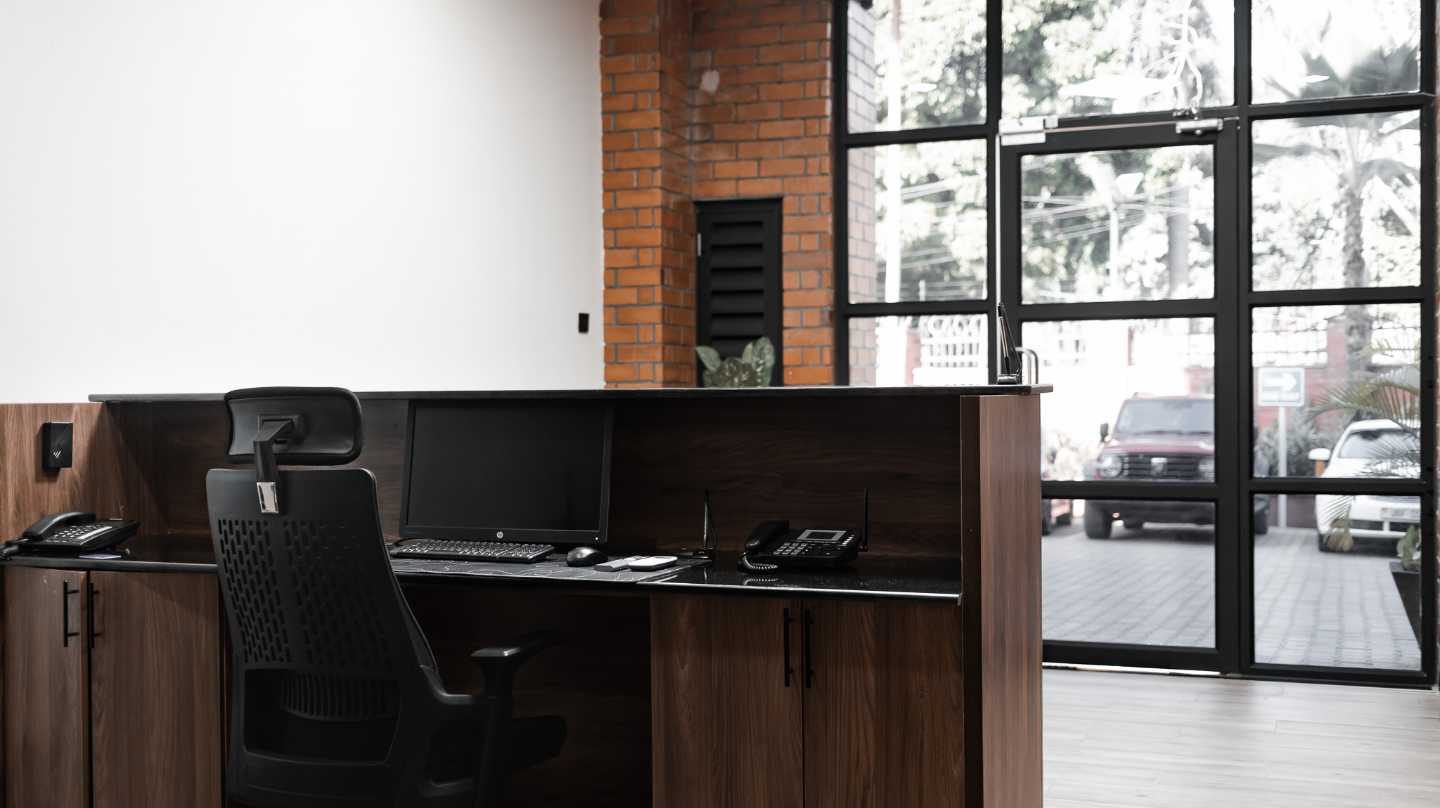 Formal meeting room with oval table and wall-mounted TV